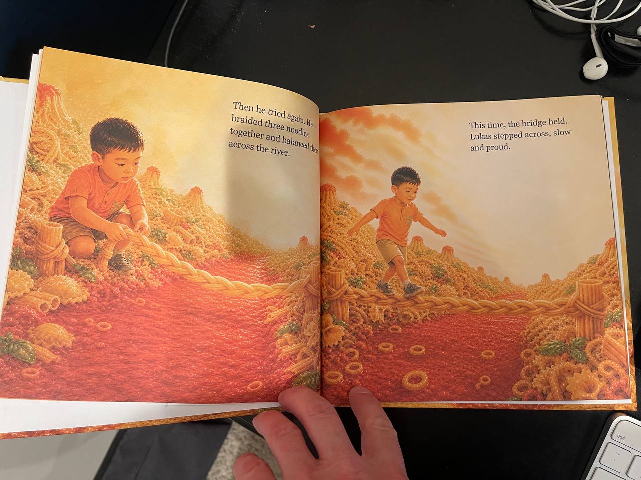 A real casewrap hardcover opened to the pasta bridge story spread