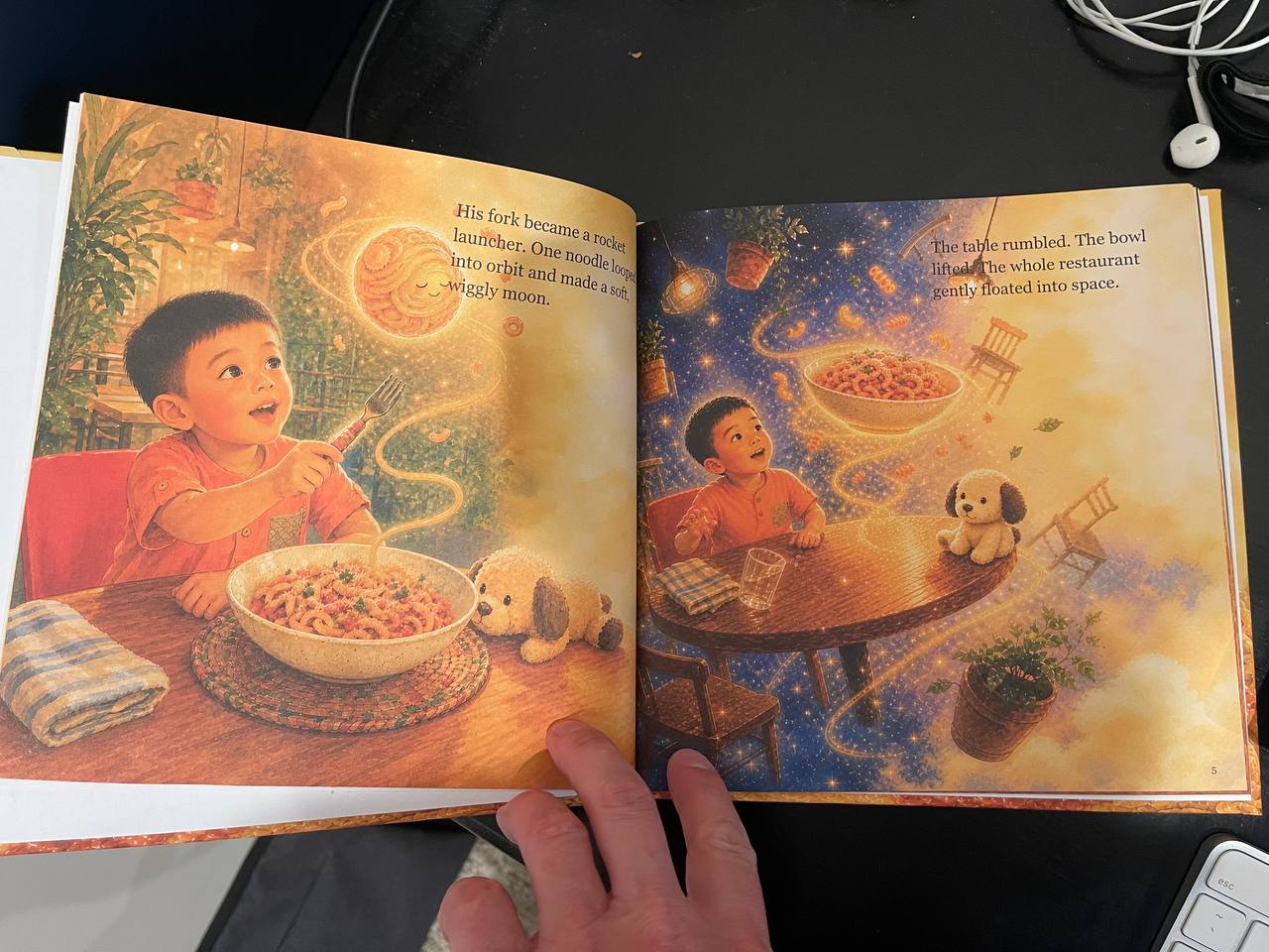A real casewrap hardcover opened to the illustrated pasta space spread